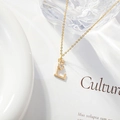 Minimalist gold necklace with capital letter L pendant and zircon studded flower detail - Letter L