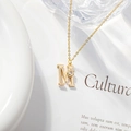 Gold plated initial M necklace with tiny flower and sparkling cubic zirconia pendant - Letter M