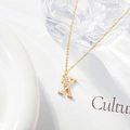 Minimalist gold letter K necklace with zircon flower pendant on a dainty chain - Letter X