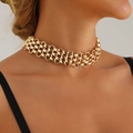 Detailed close-up of chunky gold-plated woven choker necklace with metallic mesh texture - Necklace / Gold