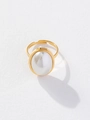 Close-up of golden adjustable ring with a large white oval faux pearl on white background - Oval Pearl Ring (D215)