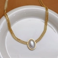 Vintage gold wide chain necklace with a large oval pearl pendant on a white ceramic plate - Oval Artificial Pearl Necklace (X1377)
