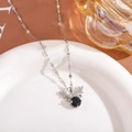Detail of silver reindeer pendant with a black center stone and pavé accents - Choker Necklace / Black