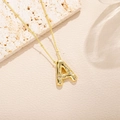 Detailed view of gold letter A pendant with sparkling round zircons on a beaded chain - Letter A Style (A)