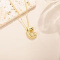Macro view of gold letter C pendant with sparkling zircons on a delicate bead chain - Letter C Style (C)
