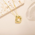 Detailed view of gold-plated letter D pendant featuring textured surface and zircon stones - Letter D Style (D)