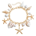 Golden ocean charm bracelet with starfish, white shells and pearls for summer beach style - Gold