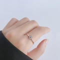 Minimalist 18k rose gold daisy flower ring for women shown on a finger macro view - US 5 / White Daisy