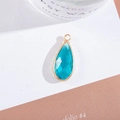 Macro detail of a sky blue teardrop crystal pendant with gold-plated metal frame for jewelry - Outer Size 11x25mm / Lake Blue