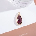 Macro shot of faceted teardrop purple crystal pendant with gold-plated metal border - Outer Size 11x25mm / Medium Purple