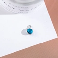 Macro detail of a round blue faceted crystal pendant with silver plated metal bezel setting - Outer Size 6.5x10mm / Peacock Blue