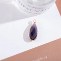 Detailed close-up of a purple teardrop crystal pendant with gold-plated metal frame - Outer Size 11x25mm / Violet
