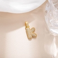 Macro view of iced out bubble letter K pendant with micro-paved cubic zirconia stones - Letter K (BGQZM003)