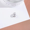 Macro detail of a silver round pendant with a multi-faceted clear crystal stone inlay - Outer Size 6.5x10mm / White