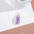 Detail of faceted purple crystal teardrop pendant with gold-plated frame and ring - Outer Size 11x25mm / Crystal Purple