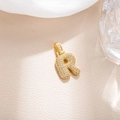 Macro detail of gold-plated bubble letter R pendant with sparkling zircon inlay - Letter R (BGQZM003)