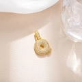 Detail of gold plated letter Q pendant with cubic zirconia on beige leather background - Letter Q (BGQZM003)