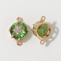 Macro detail of gold plated round green crystal connector with small zircon flower charms - Green