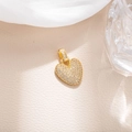 Macro shot of gold heart pendant with micro-pave white zircon inlay on leather texture - Letter V (BGQZM003)