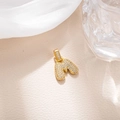 Macro detail of a gold plated bubble letter M pendant with micro-paved zircons in hip hop style - Letter M (BGQZM003)