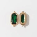Detail of dark green faceted gemstone pendant with gold plated textured metal frame - Green