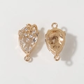 Detailed macro view of gold-plated waterdrop pendant connector with sparkling crystals - White