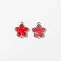 Detail of red marble star charms with silver milgrain edges and dual connection loops - Red