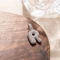Detailed macro view of silver letter R pendant featuring micro-pave zircon craftsmanship - Letter R