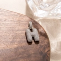 Macro view of iced out bubble letter H pendant with micro paved sparkling zircon stones - Letter H
