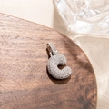 Macro shot of micro-paved zircon lowercase letter c pendant in silver-tone metal - Letter C