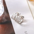 Macro shot of silver wide hoop earrings with multi-row clear cubic zirconia pavé setting - Silver