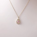 Elegant gold necklace with a pink pear-shaped gemstone pendant and white micro-diamonds - Gold With Pink Stone And Bowknot