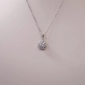 Macro detail of teardrop sapphire pendant with halo crystals on silver chain necklace - Silver With Transparent Main Stone