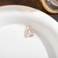 Elegant gold-plated teardrop pendant featuring a clear sparkling zircon stone inlay - White
