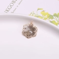 Golden flower pendant with smoky grey faceted crystal and elegant wavy metal edges - Gray