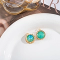 Macro detail of bird nest pendant with colorful crystal and golden hollow frame - D1-59