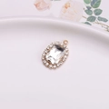 Golden oval pendant with emerald-cut crystal and diamond halo for jewelry making - White