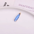 Faceted blue crystal teardrop pendant with a refined golden metal frame for jewelry making - Light Blue