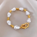 Baroque pearl and textured gold chain bracelet with toggle clasp on silk background - 32# Bracelet - Gold