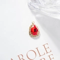 Golden teardrop pendant with vibrant red crystal and sparkling diamond-style border - Red