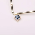 Square blue crystal pendant with diamond halo on golden metal display stand - Ink Blue