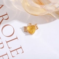 Gold-plated wing pendant featuring a vibrant yellow heart-shaped crystal charm - Gold
