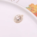 Oval crystal pendant with double halo of white zircons and gold metal finish - White