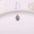 Oval crystal pendant with red, blue, and orange gradient in golden claw setting - Red Blue Orange Gradient (A16-628)