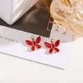 Detailed close-up of red crystal butterfly charms with gold base for DIY jewelry - Red