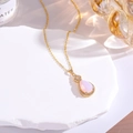 Macro detail of pink teardrop gemstone necklace with gold-plated micro-pave setting - Pink Jade