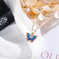 Detail of a gold butterfly necklace with blue gradient crystal and micro-pave zircons - Blue