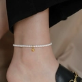 Minimalist pearl anklet featuring a small golden bead accent on an elegant ankle - Gold Pearl Anklet (2111)
