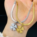 Collane a quadrifoglio in oro e argento con catena a spina di pesce sulla mano - Oro