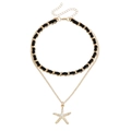 Goudkleurige dubbellaagse choker met zwart fluweel, zeester hanger en witte parels - Zeester Hanger Stijl